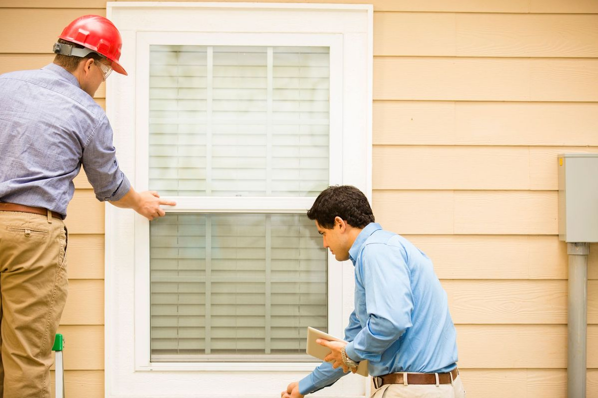 Window Dudes technician inspecting a window during an in-home assessment in Springfield, MO
