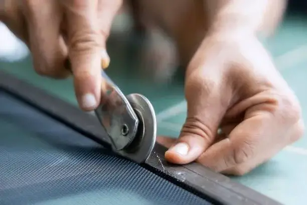Springfield technician installing spline to secure window screen mesh